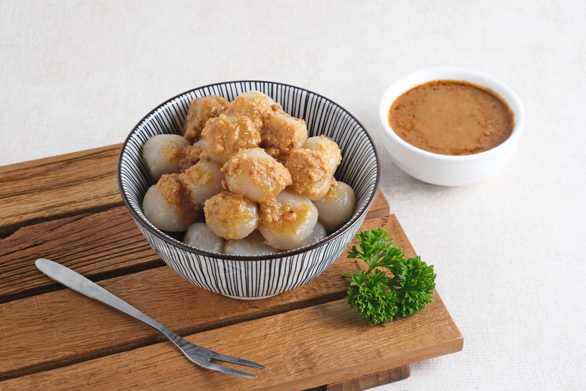 Cilok, traditional food from West Java, Indonesia, made from tapioca, chewy textured. Served with peanut sauce.